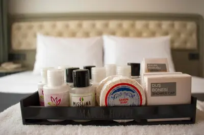 a tray of makeup products sitting on a bed at Mayer Hotel Istanbul in Istanbul