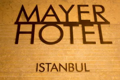 a sign that says whatever is stanub on a brick wall at Mayer Hotel Istanbul in Istanbul