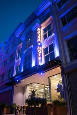 a building with a lit up sign on it at Mayer Hotel Istanbul in Istanbul