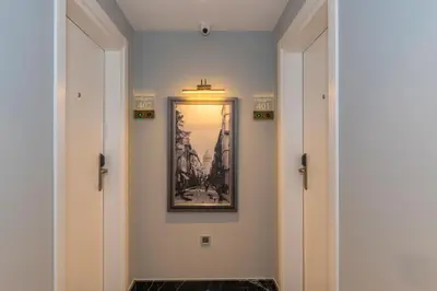 a hallway with two doors and a picture on the wall at Kare Hotel Sultanahmet in Istanbul