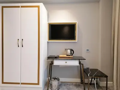 a room with a desk and a tv on a wall at Kare Hotel Sultanahmet in Istanbul