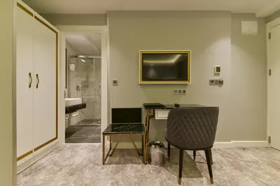 a room with a desk and a television on a wall at Kare Hotel Sultanahmet in Istanbul