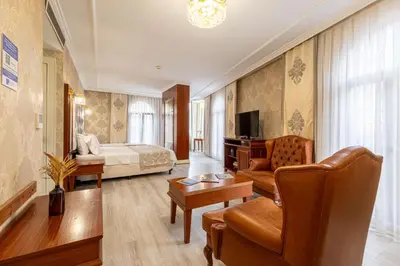 a hotel room with a bed and a living room at Myy Boutique Hotel in Istanbul