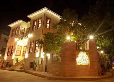 a building with a sign in front of it at night at Ada Palas Buyukada in Buyukada