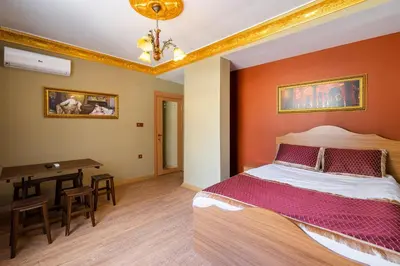 a bedroom with a large bed and a table at The Ottoman Desing Suit in Istanbul