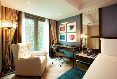a hotel room with a desk and a chair and a bed at Radisson Blu Hotel Istanbul Pera in Istanbul