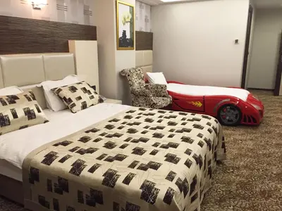 a bedroom with a bed and a car on the wall at Green Prusa Hotel in Bursa