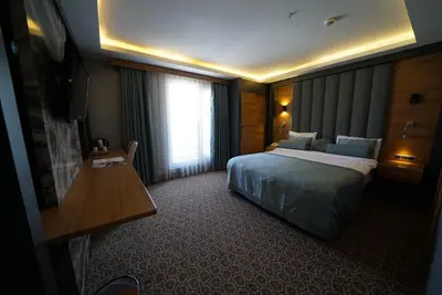 a hotel room with a bed and a window at Green Prusa Hotel in Bursa