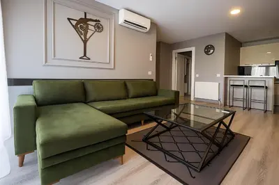 a living room with a green couch and a glass table at On4 Rooms & Suites in Istanbul