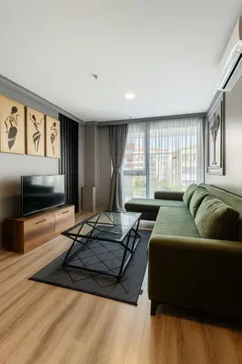 a living room with a green couch and a television at On4 Rooms & Suites in Istanbul