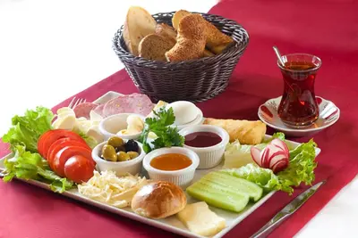 a plate of food with a basket of bread and dips at On4 Rooms & Suites in Istanbul