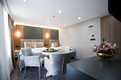 a room with a bed and a table and chairs at Grand Bagoz Hotel in Istanbul