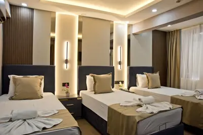 two beds in a hotel room with towels on them at Grand Bagoz Hotel in Istanbul