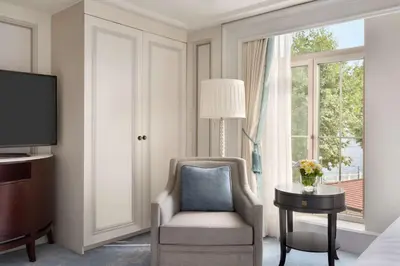 a living room with a chair and a television at Shangri-La Bosphorus, Istanbul in Istanbul