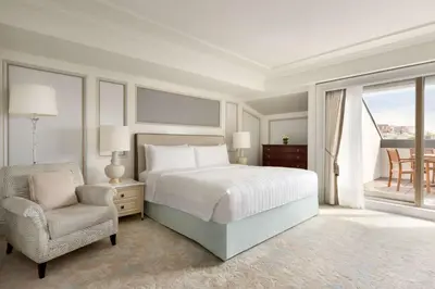a bedroom with a bed and a chair and a window at Shangri-La Bosphorus, Istanbul in Istanbul