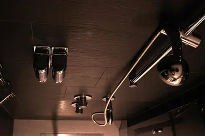 two glasses are hanging from the ceiling of a bathroom at Frida Suites in Istanbul