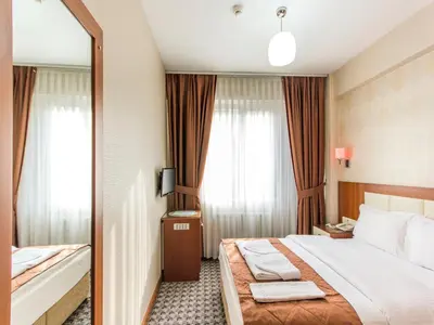 a hotel room with a bed and a mirror at Mint Residence Taksim in Istanbul