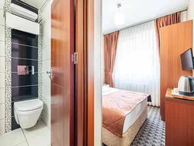 a hotel room with a bed and a toilet at Mint Residence Taksim in Istanbul