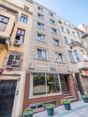 a tall building with potted plants in front of it at Mint Residence Taksim in Istanbul