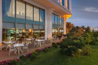 a restaurant with tables and chairs outside of a building at Elite World Istanbul Florya in Istanbul
