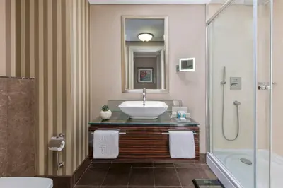 a bathroom with a sink and a shower at Elite World Istanbul Florya in Istanbul