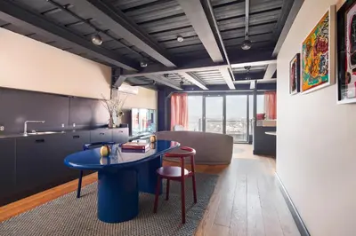 a kitchen with a blue table and a couch at Stay Lab Residence in Istanbul
