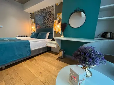 a bedroom with a bed and a table with flowers at Royal Galata Hotel in Istanbul