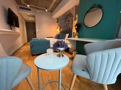 a room with a bed and a table and chairs at Royal Galata Hotel in Istanbul