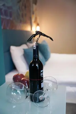 a bottle of wine sitting on a table with glasses at Royal Galata Hotel in Istanbul