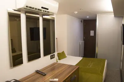 a bedroom with a bed and a tv on the wall at The 22 Hotel in Istanbul