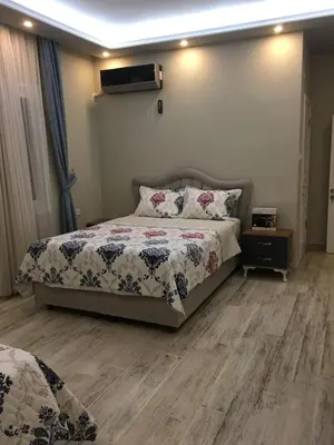 a bedroom with a bed and a television on the wall at PASHA APART~BOUTİQUE HOTEL/YALOVA in Yalova
