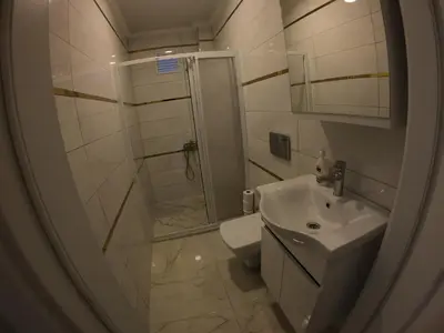a bathroom with a shower and a toilet and a sink at PASHA APART~BOUTİQUE HOTEL/YALOVA in Yalova