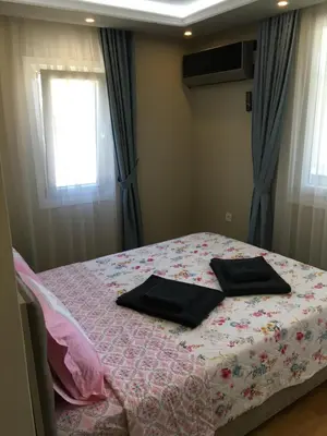 a bedroom with a bed with two pillows on it at PASHA APART~BOUTİQUE HOTEL/YALOVA in Yalova