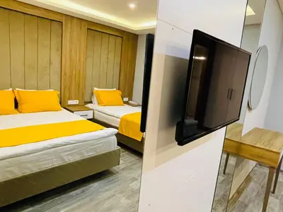 a room with two beds and a flat screen tv at Zem Hotel in Istanbul