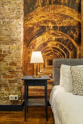 a bedroom with a bed and a table with a lamp at Ganbaru Tours - Flats in Galata in Istanbul