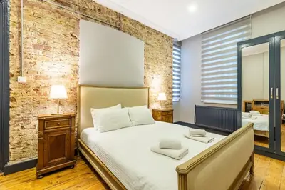 a bedroom with a bed and a brick wall at Ganbaru Tours - Flats in Galata in Istanbul