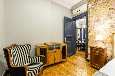 a living room with a chair and a tv at Ganbaru Tours - Flats in Galata in Istanbul