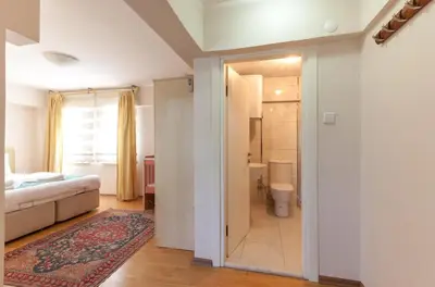 a bedroom with a bed and a bathroom with a toilet at Sultan Apartments in Istanbul