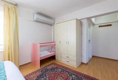 a white bedroom with a crib and a crib at Sultan Apartments in Istanbul