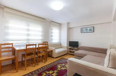 a living room with a table and a couch at Sultan Apartments in Istanbul