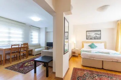 a bedroom with a bed and a dining room at Sultan Apartments in Istanbul