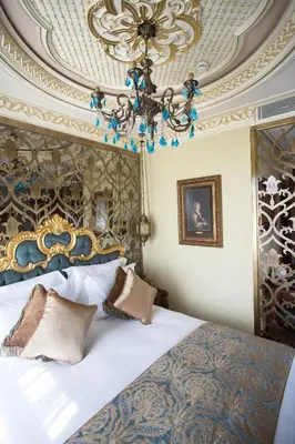 a bedroom with a bed and a chandelier at Daru Sultan Hotels Galata in Istanbul
