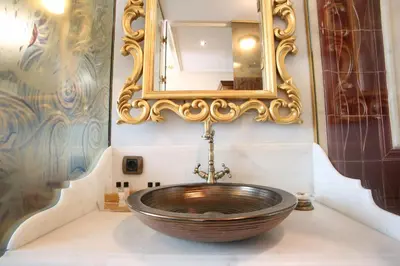 a bathroom with a wooden sink and a mirror at Daru Sultan Hotels Galata in Istanbul