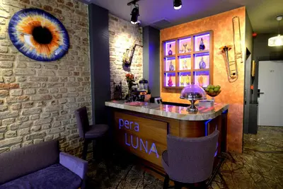 a bar in a restaurant with a stone wall at Pera Luna Residence in Istanbul