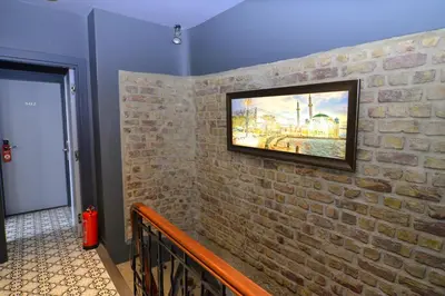a painting on a brick wall in a hallway at Pera Luna Residence in Istanbul