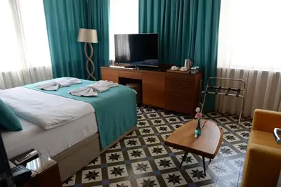 a hotel room with a bed and a television at Pera Luna Residence in Istanbul