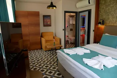 a hotel room with a bed and a chair at Pera Luna Residence in Istanbul