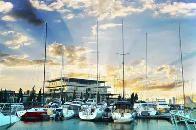 a group of boats docked in a marina with a building at Ataköy Marina Park Hotel Residence in Istanbul