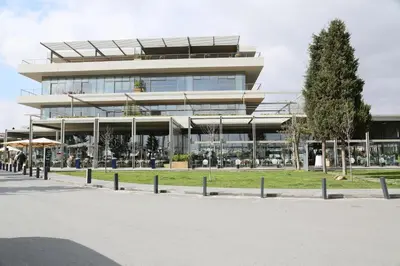 a large building with a tree in front of it at Ataköy Marina Park Hotel Residence in Istanbul