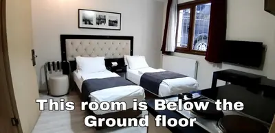 a hotel room with two beds and a room with a room at Invictum Residence in Istanbul